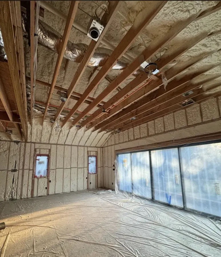 Interior walls and ceiling insulated with spray foam during new construction in Bondurant